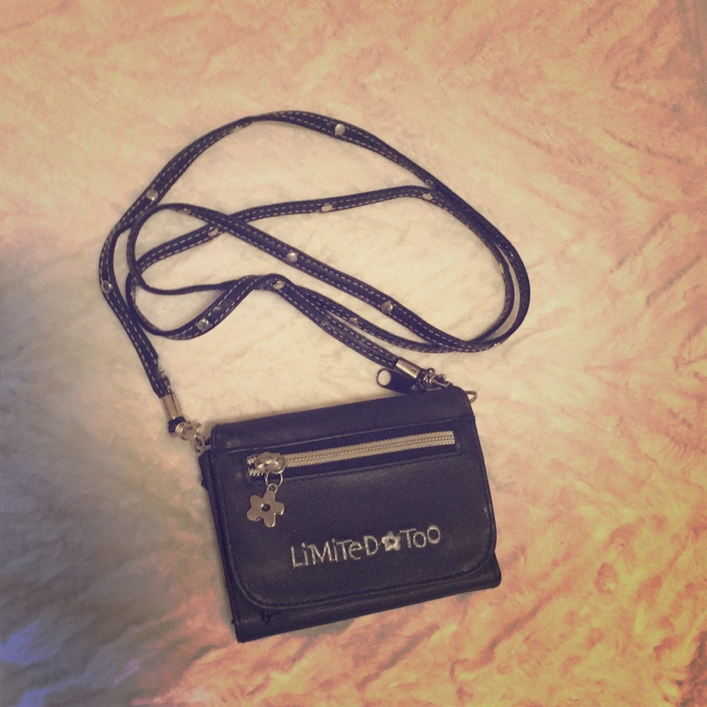 Small black shoulder wallet with detachable strap.